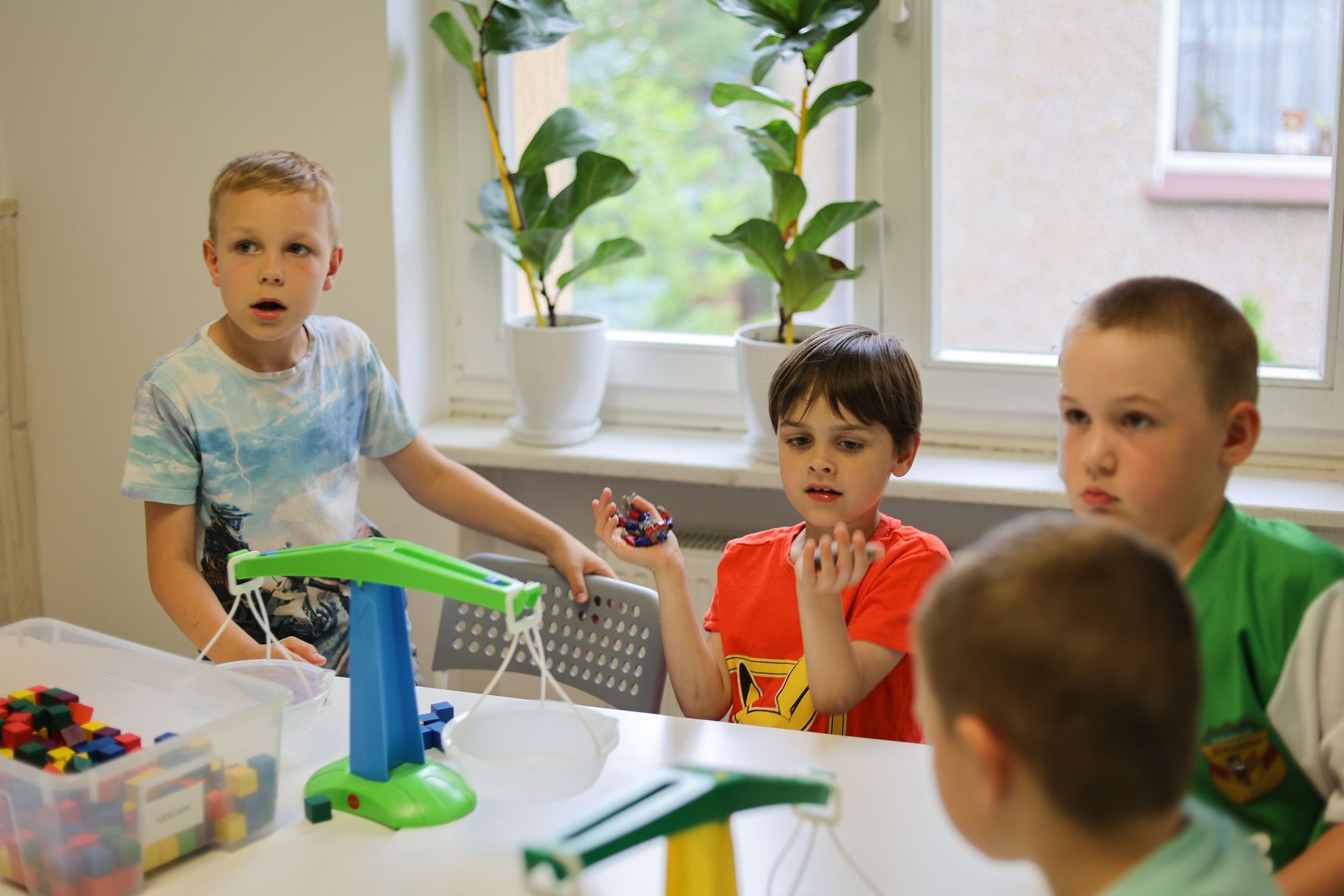 Dzieci ważą klocki i porównują wagę kilograma i grama